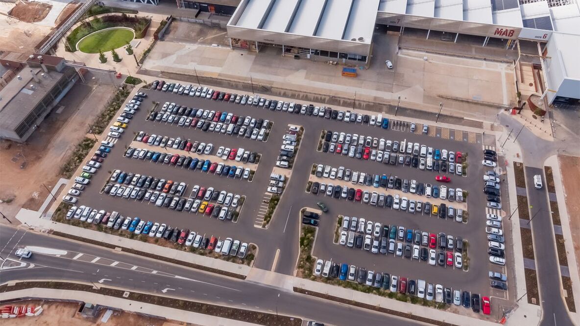 Daytime aerial view of a carpark with most spaces occupied by vehicles outside of the Tonsley MAB.